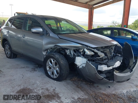 2015 Mazda CX-9 Sport with VIN JM3TB2BA0F0447436, listed as a IAAI auction lot 42480482 with 127,557 mi miles and . Bid and sale history available at DreamBid. Image 1.