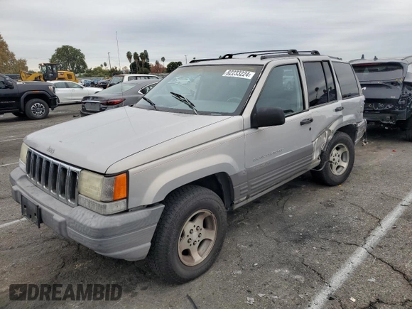 1997 Jeep Grand Cherokee Laredo with VIN 1J4GZ58S0VC771727, listed as a Copart auction lot 82233224 with 320,213 mi miles and Salvage Title. Bid and sale history available at carsss.com. Image 1.
