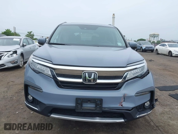 2022 Honda Pilot Touring 7-Passenger with VIN 5FNYF6H68NB056077, listed as a IAAI auction lot 42357338 with 18,193 mi miles and . Bid and sale history available at DreamBid. Image 12.