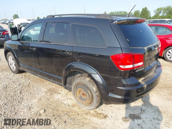 2013 Dodge Journey SE with VIN 3C4PDCAB9DT561701, listed as a IAAI auction lot 42403322 with 143,766 mi miles and . Bid and sale history available at DreamBid. Image 3.