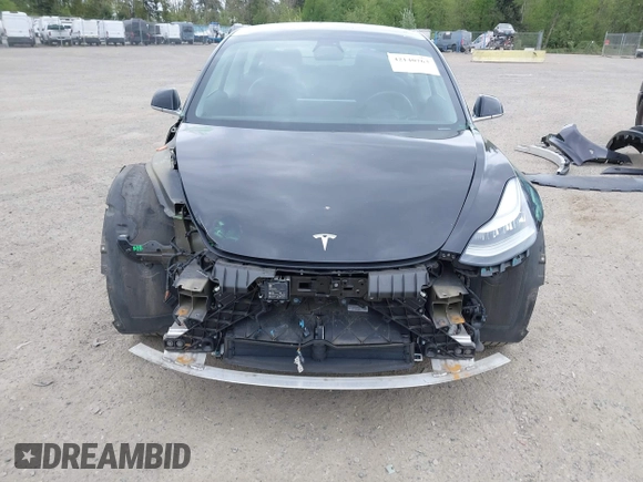 2019 Tesla Model 3 Mid Range with VIN 5YJ3E1EA6KF415656, listed as a IAAI auction lot 42140763 with 71,408 mi miles and . Bid and sale history available at carsss.com. Image 6.