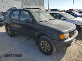 1999 Isuzu Rodeo S with VIN 4S2CK58W7X4357230, listed as a Copart auction lot 85214894 with 130,370 mi miles and Salvage title. Bid and sale history available at DreamBid. Image 4.