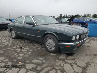 1996 Jaguar XJ with VIN SAJHX1741TC758740, listed as a Copart auction lot 73377914 with 140,964 mi miles and Salvage title. Bid and sale history available at DreamBid. Image 4.