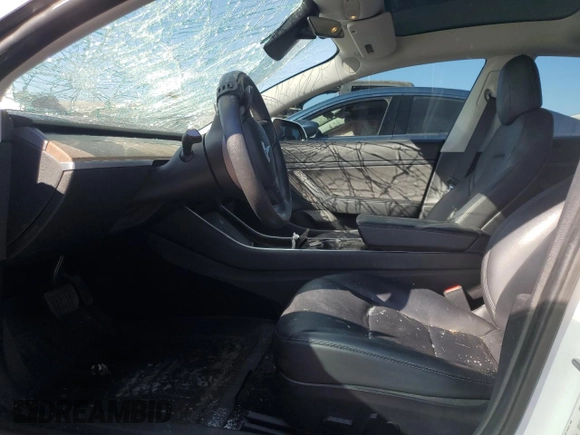 2020 Tesla Model 3 Standard Range Plus with VIN 5YJ3E1EA4LF799597, listed as a Copart auction lot 76401374 with 77,506 mi miles and Salvage Title. Bid and sale history available at DreamBid. Image 7.