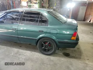 1996 Toyota Tercel DX z VIN JT2BC52L7T7044201, wystawiony jako Copart lot #77190074 z przebiegiem Nie podano mil oraz Szkoda całkowita • Salvage title. Historia ofert i sprzedaży dostępna na DreamBid. Obrazek 10.