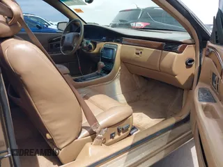 1999 Cadillac Eldorado ESC z VIN 1G6EL12Y5XU603764, wystawiony jako IAAI lot #42368692 z przebiegiem 154 613 mil mil oraz . Historia ofert i sprzedaży dostępna na DreamBid. Obrazek 5.