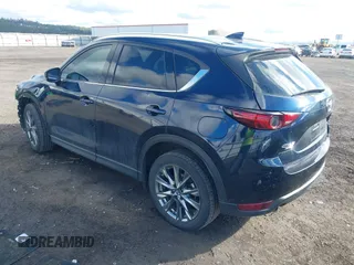 2019 Mazda CX-5 Signature with VIN JM3KFBEY5K0609063, listed as a IAAI auction lot 41802772 with 104,112 mi miles. Bid and sale history available at carsss.com. Image 3.