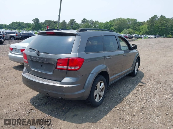 2013 Dodge Journey American Value z VIN 3C4PDCAB0DT691429, wystawiony jako IAAI lot #42514055 z przebiegiem 213 593 mil mil oraz . Historia ofert i sprzedaży dostępna na DreamBid. Obrazek 4.