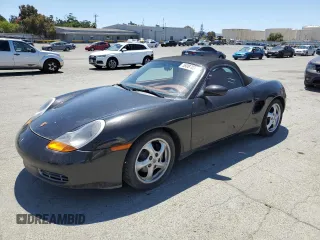 2000 Porsche Boxster z VIN WP0CA2983YU620909, wystawiony jako Copart lot #58087035 z przebiegiem 99 845 mil mil oraz Czysty tytuł • Clean title. Historia ofert i sprzedaży dostępna na DreamBid. Obrazek 1.