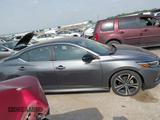 2021 Nissan Sentra SR z VIN 3N1AB8DV6MY219756, wystawiony jako IAAI lot #42257180 z przebiegiem 55 867 mil mil oraz . Historia ofert i sprzedaży dostępna na DreamBid. Obrazek 13.