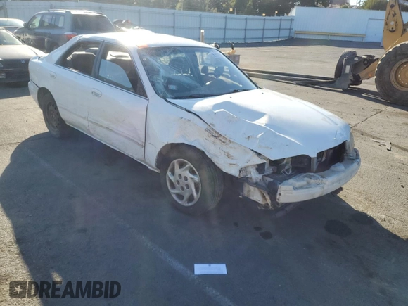 1999 Mazda 626 LX z VIN 1YVGF22D4X5882600, wystawiony jako Copart lot #69031604 z przebiegiem Nie podano mil oraz Szkoda całkowita • Salvage title. Historia ofert i sprzedaży dostępna na DreamBid. Obrazek 4.