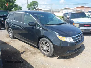 2012 Honda Odyssey EX-L with VIN 5FNRL5H65CB060351, listed as a IAAI auction lot 42730279 with 107,436 mi miles and . Bid and sale history available at DreamBid. Image 1.
