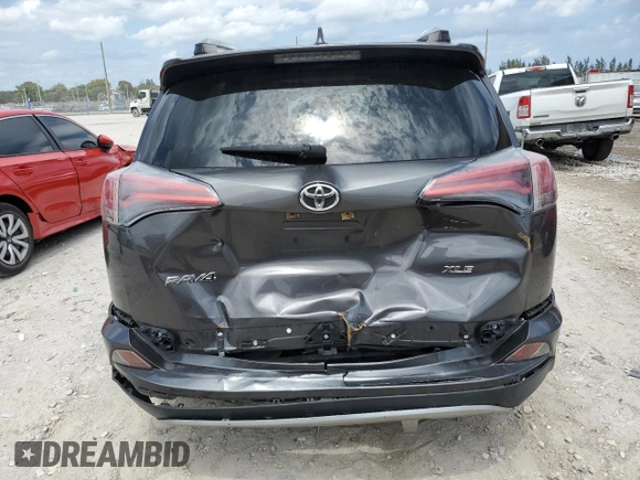 2018 Toyota RAV4 XLE with VIN JTMWFREV1JJ742694, listed as a Copart auction lot 51093695 with 74,502 mi miles and Salvage Title. Bid and sale history available at DreamBid. Image 6.