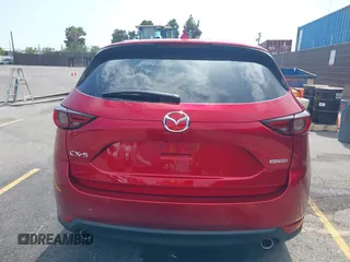 2021 Mazda CX-5 Grand Touring with VIN JM3KFADM6M1373111, listed as a IAAI auction lot 42784431 with 14,374 mi miles and . Bid and sale history available at DreamBid. Image 16.