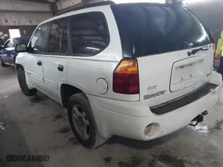 2004 GMC Envoy SLE with VIN 1GKDS13S642118163, listed as a IAAI auction lot 41809472 with 234,353 mi miles. Bid and sale history available at carsss.com. Image 3.