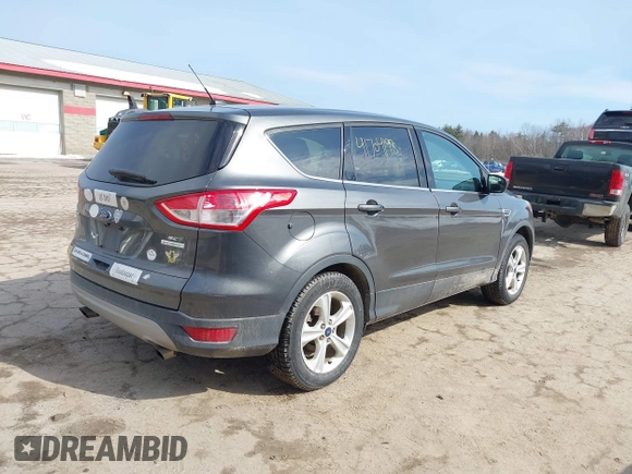 2015 Ford Escape SE with VIN 1FMCU0GXXFUB99852, listed as a IAAI auction lot 41704198 with 84,735 mi miles. Bid and sale history available at carsss.com. Image 4.