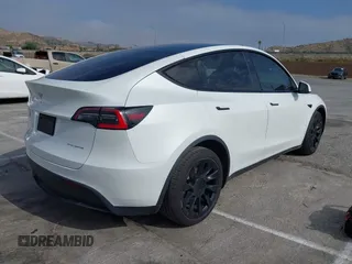 2021 Tesla Model Y Long Range with VIN 5YJYGDEE0MF069451, listed as a IAAI auction lot 41482649 with 55,542 mi miles. Bid and sale history available at carsss.com. Image 4.