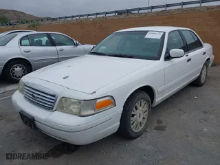 2003 Ford Crown Victoria LX with VIN 2FAFP74WX3X154904, listed as a IAAI auction lot 42094274 with 123,579 mi miles. Bid and sale history available at carsss.com. Image 2.