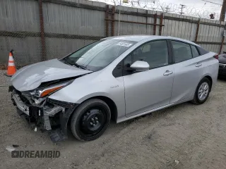 2021 Toyota Prius L Eco z VIN JTDKAMFUXM3150256, wystawiony jako Copart lot #54801665 z przebiegiem 122 979 mil mil oraz Szkoda całkowita • Salvage title. Historia ofert i sprzedaży dostępna na DreamBid. Obrazek 1.