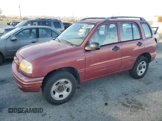 1999 Suzuki Vitara JX z VIN 2S3TD52V6X6101702, wystawiony jako Copart lot #42596125 z przebiegiem 225 614 mil mil oraz Tytuł czysty. Historia ofert i sprzedaży dostępna na DreamBid. Obrazek 1.