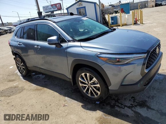 2023 Toyota Corolla Cross XLE with VIN 7MUDAAAG0PV063242, listed as a Copart auction lot 52511585 with 10,695 mi miles and Salvage title. Bid and sale history available at DreamBid. Image 4.