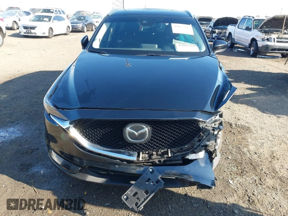 2020 Mazda CX-5 Grand Touring with VIN JM3KFBDM0L0790508, listed as a IAAI auction lot 41883319 with 114,398 mi miles and . Bid and sale history available at carsss.com. Image 6.