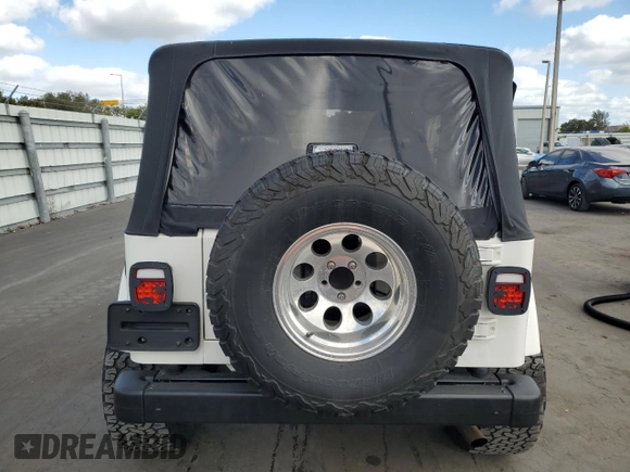 1999 Jeep Wrangler Sahara with VIN 1J4FY49SXXP414414, listed as a Copart auction lot 41643665 with 154,810 mi miles and Salvage Title. Bid and sale history available at carsss.com. Image 6.