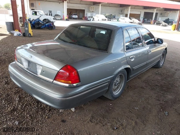 1999 Ford Crown Victoria LX with VIN 2FAFP74W9XX233325, listed as a IAAI auction lot 40934834 with 176,845 mi miles. Bid and sale history available at carsss.com. Image 4.
