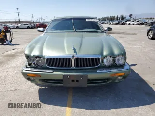 1999 Jaguar XJ with VIN SAJHX604XXC854217, listed as a Copart auction lot 56042735 with 127,092 mi miles and Salvage title. Bid and sale history available at DreamBid. Image 5.