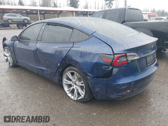 2022 Tesla Model 3 Long Range with VIN 5YJ3E1EB1NF142574, listed as a IAAI auction lot 41213900 with 127,404 mi miles and . Bid and sale history available at DreamBid. Image 3.