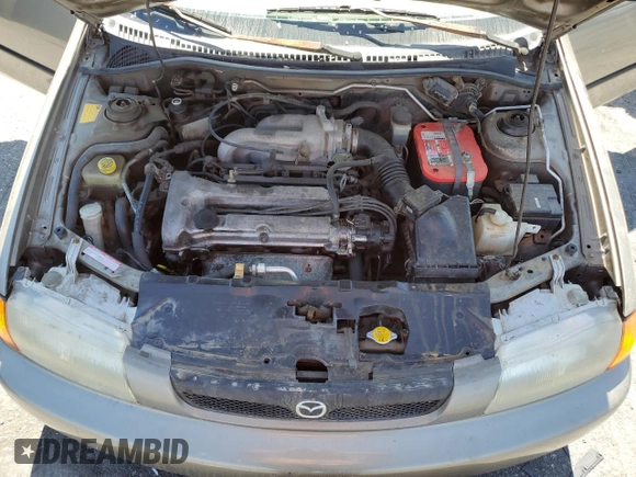 1998 Mazda Protege DX z VIN JM1BC1414W0203670, wystawiony jako Copart lot #62966544 z przebiegiem 249 405 mil mil oraz Szkoda całkowita • Salvage title. Historia ofert i sprzedaży dostępna na DreamBid. Obrazek 11.