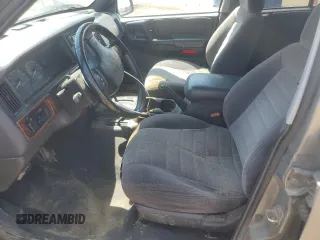 1997 Jeep Grand Cherokee Laredo z VIN 1J4GZ58S6VC636803, wystawiony jako Copart lot #59977115 z przebiegiem Nie podano mil oraz Szkoda całkowita • Salvage title. Historia ofert i sprzedaży dostępna na DreamBid. Obrazek 7.