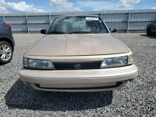 1991 Toyota Camry DLX z VIN 4T1SV21E5MU415356, wystawiony jako Copart lot #74465914 z przebiegiem 74 592 mil mil oraz Szkoda całkowita • Salvage title. Historia ofert i sprzedaży dostępna na DreamBid. Obrazek 5.