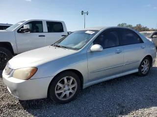 2006 Kia Spectra EX with VIN KNAFE121365229594, listed as a Copart auction lot 77311084 with 129,789 mi miles and Salvage Title. Bid and sale history available at carsss.com. Image 1.