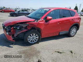 2014 Mazda CX-5 Touring with VIN JM3KE2CY5E0354781, listed as a Copart auction lot 64905035 with 113,430 mi miles and Salvage title. Bid and sale history available at DreamBid. Image 1.