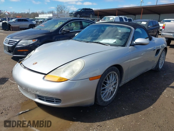 1999 Porsche Boxster z VIN WP0CA2989XU627152, wystawiony jako IAAI lot #41805432 z przebiegiem 112 380 mil mil oraz . Historia ofert i sprzedaży dostępna na DreamBid. Obrazek 2.