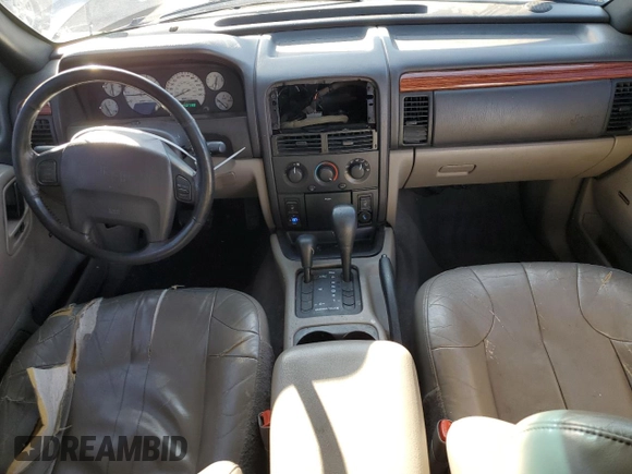 1999 Jeep Grand Cherokee Laredo with VIN 1J4GW58N9XC633464, listed as a Copart auction lot 84682454 with 212,738 mi miles and Salvage title. Bid and sale history available at DreamBid. Image 8.