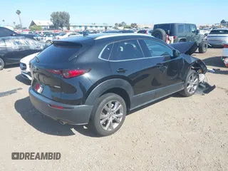 2022 Mazda CX-30 S Premium with VIN 3MVDMBDL6NM407913, listed as a IAAI auction lot 42359860 with 35,804 mi miles and . Bid and sale history available at DreamBid. Image 4.