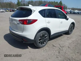 2016 Mazda CX-5 Grand Touring with VIN JM3KE4DY0G0632693, listed as a IAAI auction lot 42123142 with 106,592 mi miles. Bid and sale history available at carsss.com. Image 4.