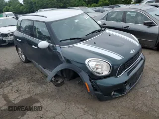 2014 MINI Countryman S with VIN WMWZC5C58EWP39797, listed as a Copart auction lot 62193515 with 84,989 mi miles and Salvage title. Bid and sale history available at DreamBid. Image 4.