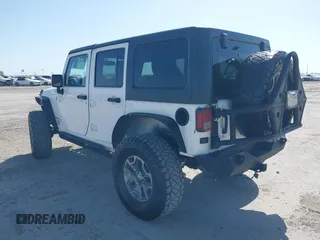 2014 Jeep Wrangler Unlimited Rubicon with VIN 1C4BJWFG1EL167423, listed as a IAAI auction lot 41861109 with 104,669 mi miles. Bid and sale history available at carsss.com. Image 3.