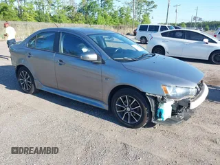 2015 Mitsubishi Lancer SE with VIN JA32V2FWXFU023626, listed as a IAAI auction lot 42012381 with 143,981 mi miles. Bid and sale history available at carsss.com. Image 1.