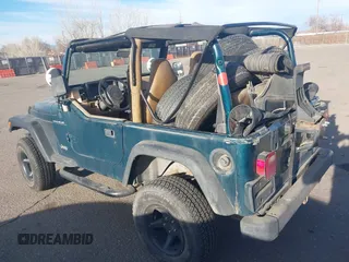 1997 Jeep Wrangler SE with VIN 1J4FY29PXVP409498, listed as a IAAI auction lot 41818698 with 150,086 mi miles. Bid and sale history available at carsss.com. Image 3.