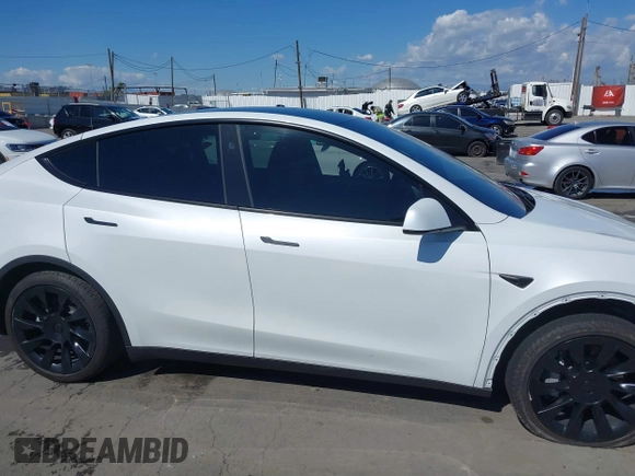 2023 Tesla Model Y Long Range with VIN 7SAYGDEEXPA129790, listed as a IAAI auction lot 41735721 with 20,402 mi miles and . Bid and sale history available at DreamBid. Image 14.
