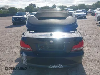 2011 BMW 1 Series 128i with VIN WBAUL7C54BVM80474, listed as a IAAI auction lot 42031032 with 76,617 mi miles and . Bid and sale history available at carsss.com. Image 16.