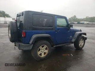 2009 Jeep Wrangler X with VIN 1J4FA24109L712701, listed as a Copart auction lot 60800855 with 156,709 mi miles and Salvage title. Bid and sale history available at DreamBid. Image 3.