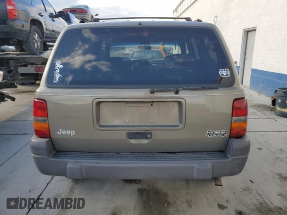 1996 Jeep Grand Cherokee Laredo with VIN 1J4GZ58S3TC245928, listed as a Copart auction lot 57313735 with 165,733 mi miles and Salvage title. Bid and sale history available at DreamBid. Image 6.