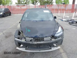 2019 Tesla Model 3 Mid Range with VIN 5YJ3E1EA3KF415601, listed as a IAAI auction lot 42125393 with 150,220 mi miles and . Bid and sale history available at carsss.com. Image 13.