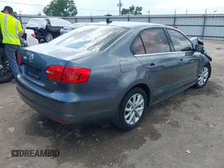 2014 Volkswagen Jetta Sedan SE with VIN 3VWD07AJ7EM238799, listed as a IAAI auction lot 40234990 with 113,297 mi miles. Bid and sale history available at carsss.com. Image 4.