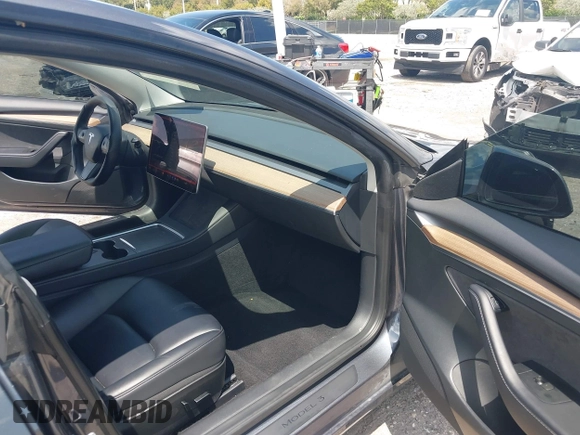 2023 Tesla Model 3 with VIN 5YJ3E1EAXPF575448, listed as a IAAI auction lot 42019288 with 33,859 mi miles and . Bid and sale history available at carsss.com. Image 5.